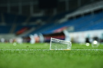 Plastic trash can on the turf on a soccer field