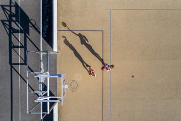 Young women playing basketball, aerial view
