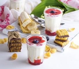 homemade yogurt in transparent glass with syrup and banana