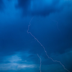 The discharge of lightning in the sky as a background