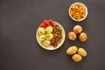 Boiled potatoes with fried chanterelle mushrooms on the plate