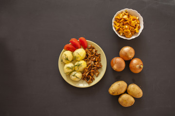 Boiled potatoes with fried chanterelle mushrooms on the plate