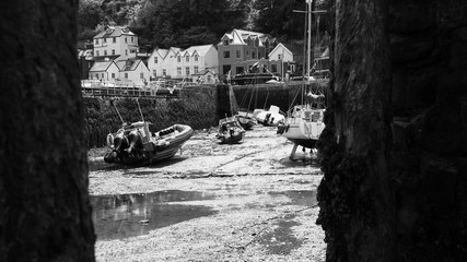 Boats moored in Lynmouth harbor at low tide