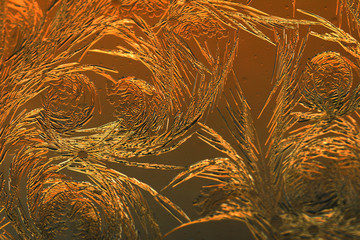 Gold frost drawings on the glass as a background