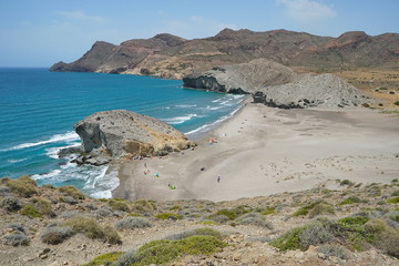 Sandy beach and rock formation on the sea shore, Playa de Mónsul in the Cabo de Gata-Níjar natural park, Mediterranean sea, Almeria, Andalusia, Spain