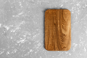 Cutting board on wooden background top view with copy space