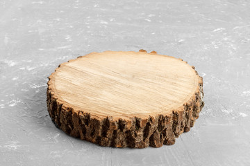 Tree stump round cut with annual rings on gray background from top view