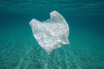 Underwater pollution a plastic bag in the sea between water surface and a sandy seabed, Mediterranean, Almeria, Andalusia, Spain