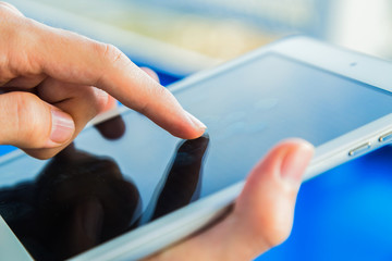 Man using a tablet pc on deck of ship