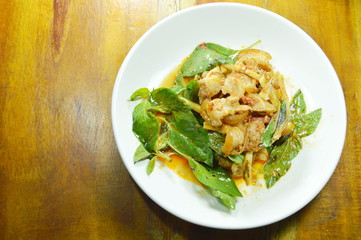 stir fried spicy wild boar and coconut shoot with red curry on plate