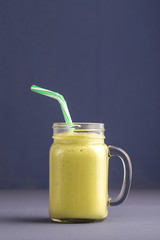 Fresh smoothies from avocado, banana, mango and honey on gray background. Closeup. Concept healthy eating