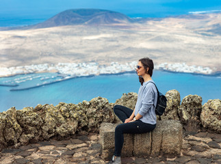 Naklejka na ściany i meble Traveler woman enjoying at viewpoint on island