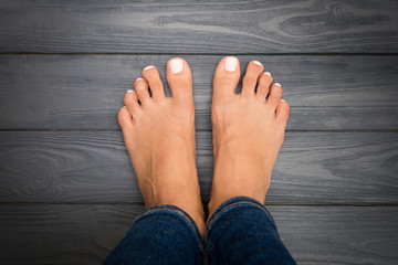 Woman legs with pink pedicure