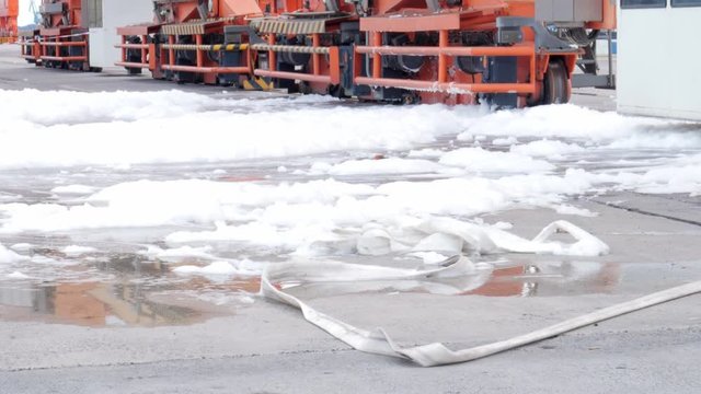 firefighters using fire-extinguishing foam
