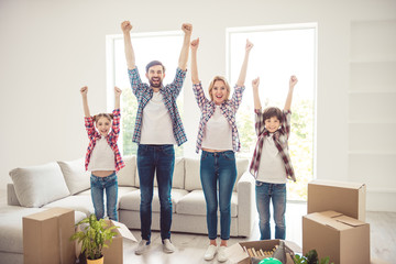 Success concept. Young happy smiling caucasian family wearing casual moving to new flat, standing...