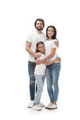 happy family in white shirts and jeans looking at camera isolated on white