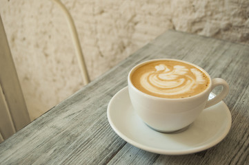 A cup of coffee on a table.