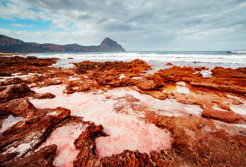 The unique shape of the volcanic beach in sunlight. Location place cape San Vito, Sicily, Italy.