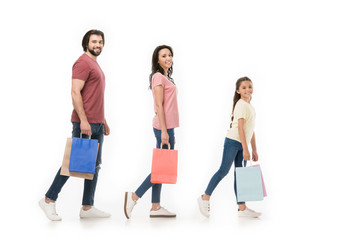 Obraz premium side view of family with shopping bags isolated on white
