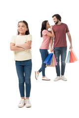 Obraz premium selective focus of little kid looking away and parents with shopping bags behind isolated on white
