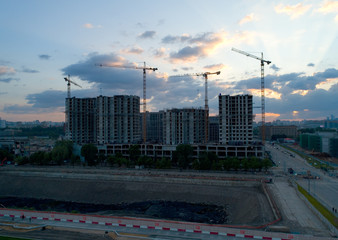 Fototapeta na wymiar Construction of a new residential complex in Moscow at sunset.