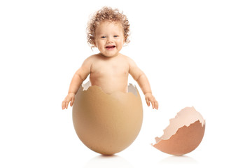 Baby boy coming out of an eggshell