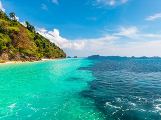 Fototapeta premium Wonderful seascape. Clear turquoise sea, forest mountain and blue sky.