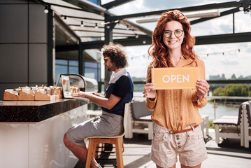 Red-haired businessman. Red-haired businessman opening her new restaurant in summer along with her boyfriend