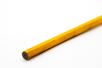 Close up on yellow pencil on white background.