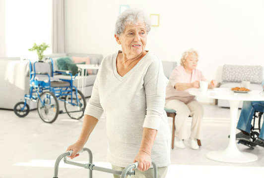 Senior woman with walkers in care home