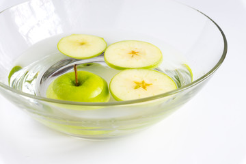 Sliced green apple in salt water