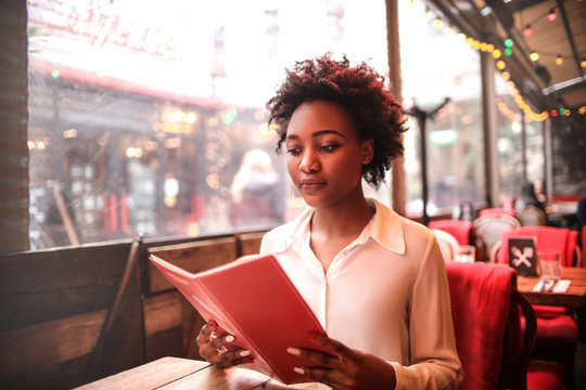 Woman Reading A Menu In A Restaurant