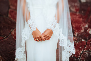 Brides hand with a manicure and wedding ring