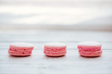 Colorful macaroons on a white desks