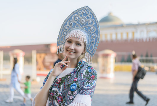 Portrait of beautiful young woman in light blue kokoshnik.