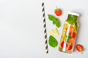 Strawberry lemon lemonade in bottle and ingredients
