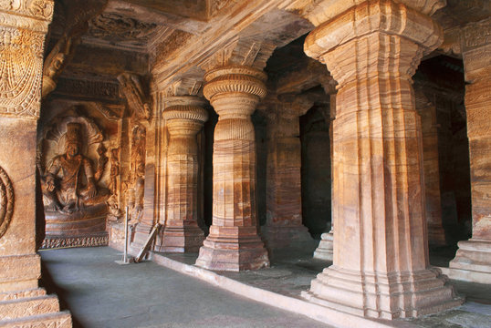 Cave 3 : Carved figures of Vishnu seated on a hooded serpent called Sesha or Ananta on the eastern side of the verandha. Badami Caves, Karnataka.