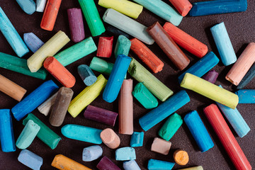 pieces of color chalk  on dark background