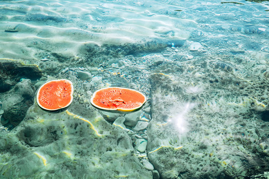 Two watermelon halfes are in the sea water