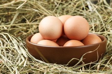 chicken eggs in a clay plate
