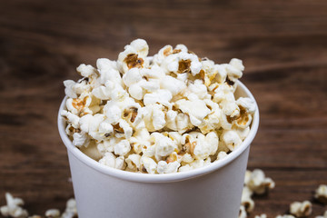 Salt popcorn on the wooden table,