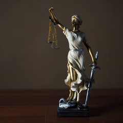 Themis with scales in lawyers office.  Statue of blind goddess 
