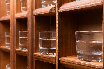 Fototapeta na wymiar perspective from wooden shelves with glasses for alcohol