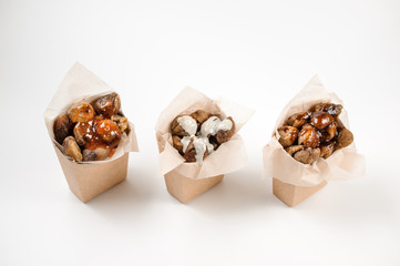 Top view of three paper packs filled with tasty chestnuts