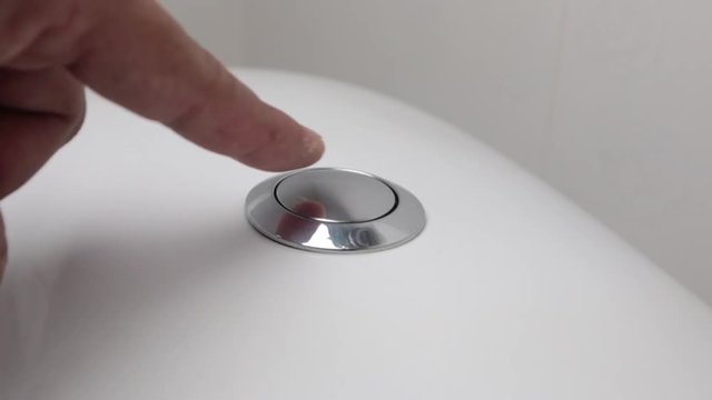 Men press on  button toilet flushing. Flush toilet, toilet flush handle.