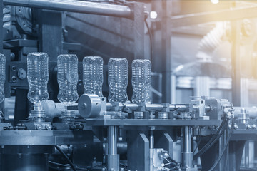 The  plastic bottles manufacturing process at the drinking factory in the light blue scene....