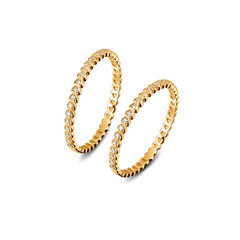 A pair of luxury yellow gold rings with diamonds on the white background, golden rings isolated