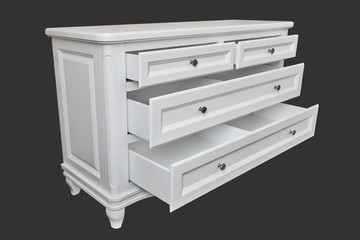 White wooden chest of drawers isolated on dark grey