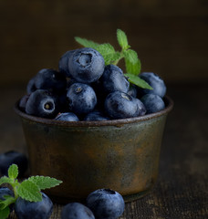 Organic healthy superfood blueberry in bowl, new harvest, raw, ready to eat ob wooden table