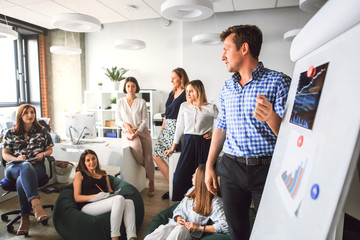 Creative business team in the office listening to the boss